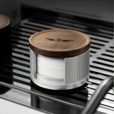 Silver filter paper holder with walnut lid on a drip tray